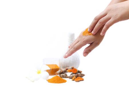 Women applying curcuma  to hands in isolated on white backgroundの写真素材