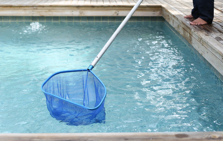 Cleaning and maintenance swimming pool with cleaning net, blue skimmer.の写真素材