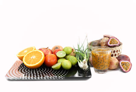 Diet concept. Fruits and vegetable with on  weight scalein white backgroundの写真素材