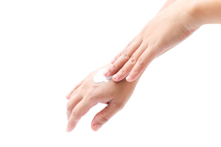 Women applying hand cream to hands in isolated on white backgroundの写真素材