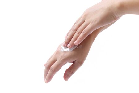 Women applying hand cream to hands in isolated on white backgroundの写真素材