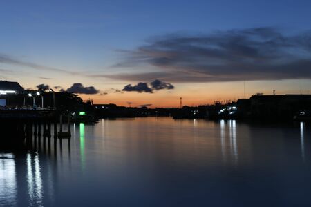 River to the Sea in Fisherman village in Thailand with stunning silhouette Sunset viewの写真素材