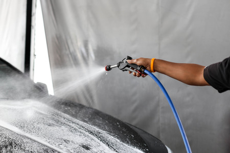 Car wash with flowing water in garageの写真素材