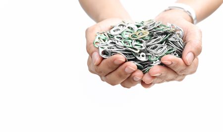 Hand holding aluminum cap can or ring pull of can in white backgroundの写真素材
