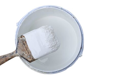 Old paint brush rest on top of  paint tin isolated in white backgroundの写真素材