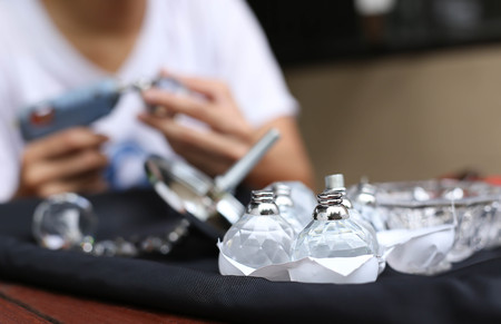 Selected focus on crystal ball with woman and glue gun in blur backgroundの写真素材