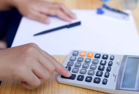 Business people's working hand on calculator on calculatingの写真素材