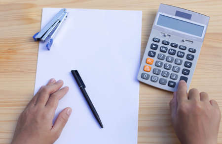 Business people's working hand on calculator on top view
