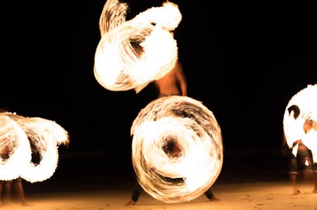 Group of people doing Fire show on beach party in Thailandの写真素材