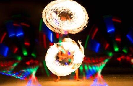 Group of people doing Fire show on beach party in Thailand