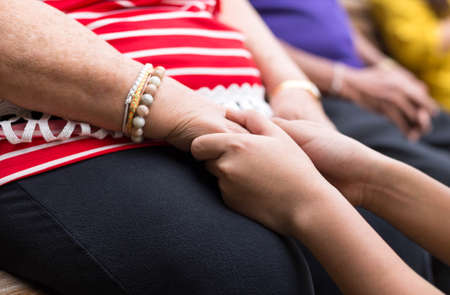 Old woman and child holding hands togetherの写真素材