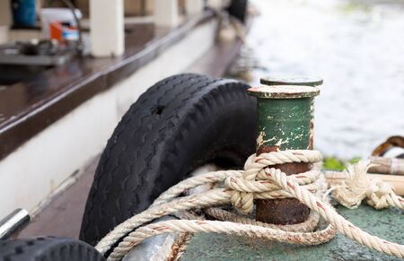 Boat rope tied to the old iron cleats on deck