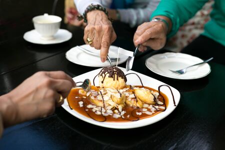 Tea time with family having bananas crepe and  ice creamの写真素材