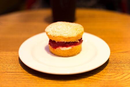 Selected focus on strawberry jam English scone on the table