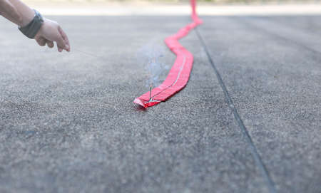 Man set fire to rocket firecracker on the concrete floor