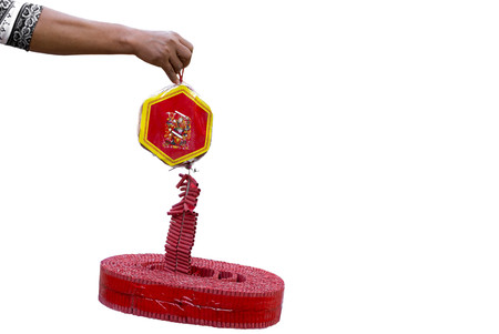 Hand holding string of firecracker isolated in white background