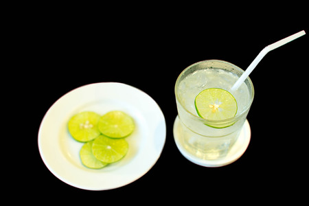 Healthy nutrition drinking water with slice of lime in white backgroundの写真素材