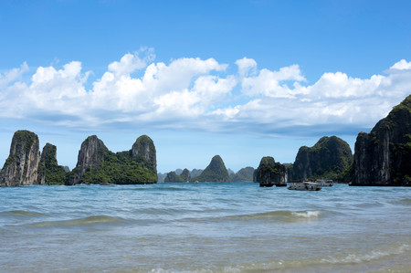 Beautiful rocky islands with touring boat with blue skyの写真素材