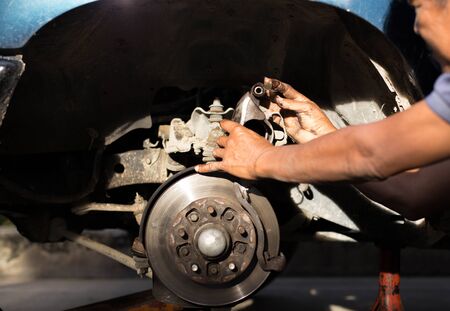 Mechanic finger dirty with oil grease for lubricant car disk break in nature sunlightの写真素材