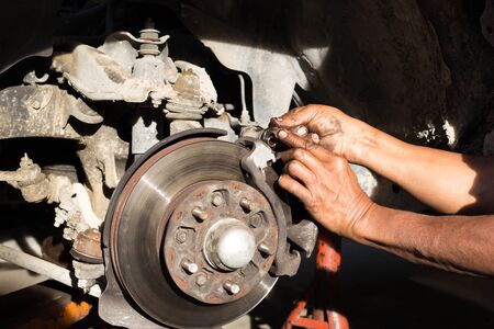 Mechanic finger dirty with oil grease for lubricant car disk break in nature sunlightの写真素材