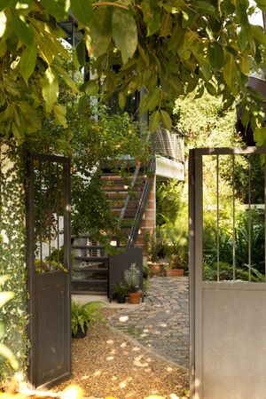 Modern metal gate and beautiful green garden in countrysideの写真素材