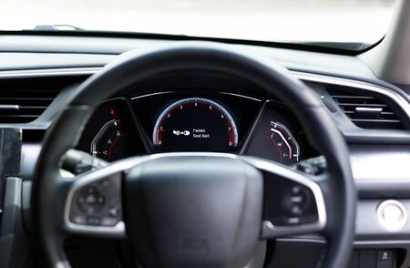 Fasten seat belt sign warning on car dashboard information for safety driverの写真素材