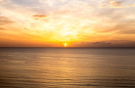 Top view of sunrise above the sea with cloud in orange toneの写真素材