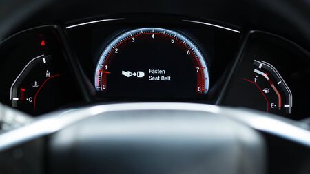 Fasten seat belt sign warning on car dashboard information for safety driverの写真素材