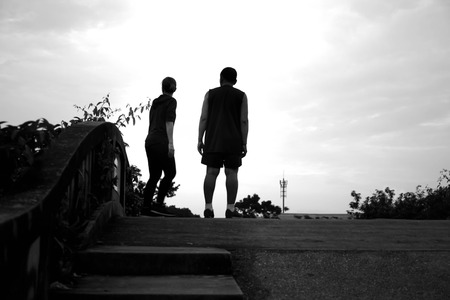 Silhouette contrast Unidentified couple jogger standing on the bridge in black and whiteの写真素材