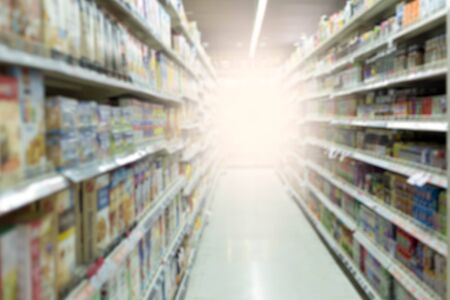 Blurred concept shelf in supper market with sunlight in the morningの写真素材
