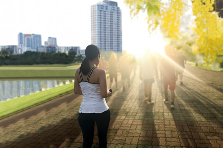 Group of people exercising  in park in the morning with sunlight and flowerの写真素材