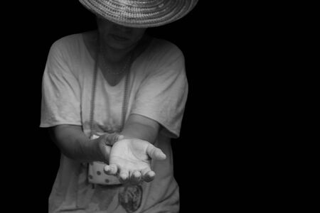 Conceptual immigrant crisis Refugee raising her hand need  help in black and whiteの写真素材