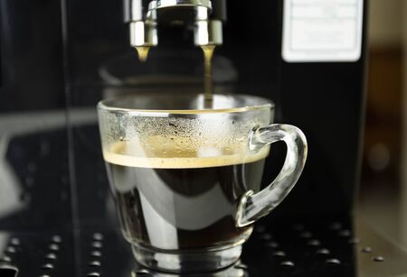 Making fresh coffee on espresso machine in coffee shopの写真素材
