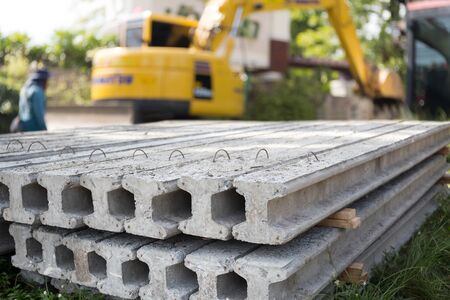 I Concrete Stake at construction site with yellow truck in backgroundの写真素材