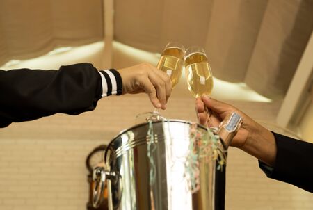 Celebration hand  holding glasses of champagne making a toastの写真素材