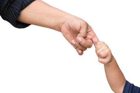 Little child holding her mother's finger while walking isolated in white backgroundの写真素材