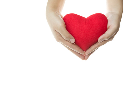 Hand holding red heart shape isolated in white backgroundの写真素材