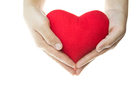 Hand holding red heart shape isolated in white backgroundの写真素材