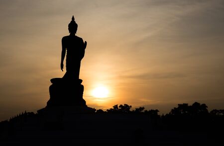 Silhouette standing big Buddha in sunset in Phutthamonthon Thailandの写真素材