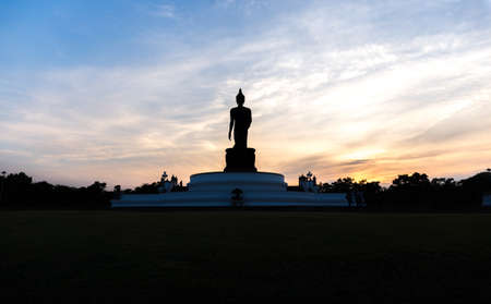 Silhouette standing big Buddha in sunset in Phutthamonthon Thailandの写真素材