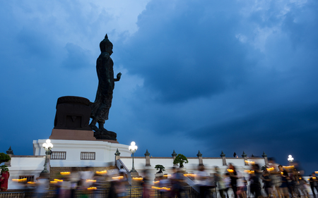 Visakabucha day Candle light trails of people walking around the big buddha in Phutthamonthon bangkok Thailandの写真素材