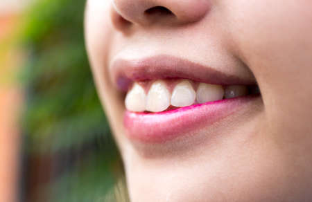 Beautiful young woman close up smiling in blur backgroundの写真素材