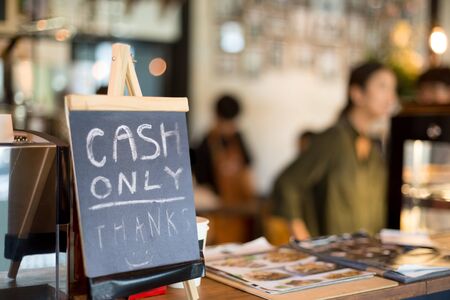 Selected focus cash only letter showing on counter consumer purchases using moneyの写真素材