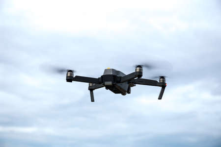 Drone with camera against the blue skyの写真素材