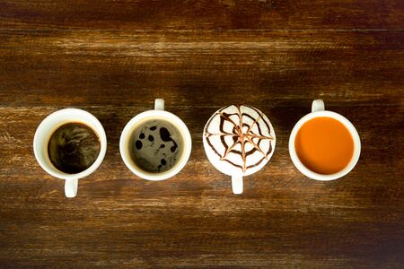 Concept and idea cup of coffee and tea line up on wooden table top viewの写真素材