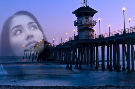 Double exposure portrait of woman face and bridge with ocean at sunset at Huntington beach Californiaの写真素材