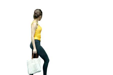 Sporty woman with blank cotton eco bag isoalted in white backgroundの写真素材