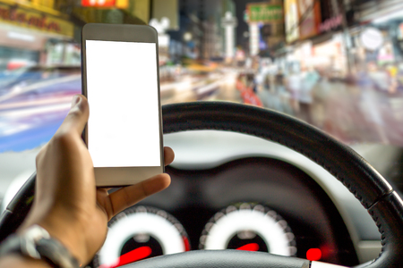 Danger concept man using cell phone while driving on the road with many peopleの写真素材