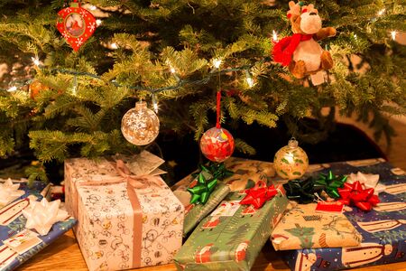 Christmas tree with decorations and present under Christmas tree for holiday celebrationの写真素材