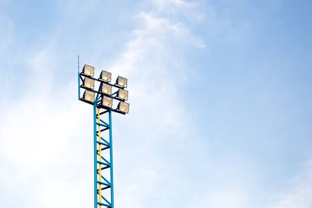 Spotlights of a soccer field with blue sky